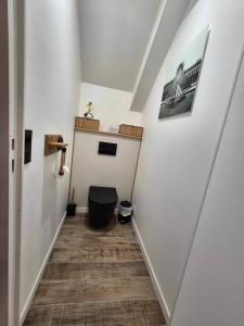 a hallway with a toilet in the middle of a room at Les Charmilles in Escoville +14 photos