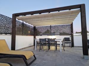 a patio with a table and chairs on a roof at La Reserva Puerto Banus in Marbella