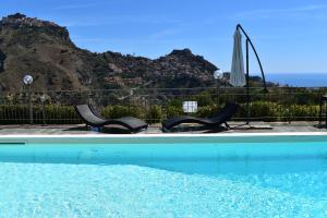 basen z dwoma krzesłami i parasolem w obiekcie Villa Victoria, Taormina w Taominie