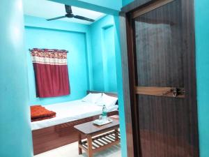 Säng eller sängar i ett rum på Hotel Ambika