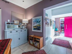 a room with purple walls and a red door at Absolute Bosch Guest House in Stellenbosch