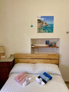 una camera da letto con un letto e asciugamani di LA GINESTRA B&B a Fosdinovo