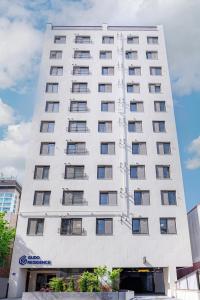 a white building with windows on the side of it at Gudo Residence Chungmuro in Seoul