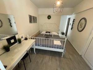 a room with a crib and a desk in it at Cocomelo Apts in Heraklio Town