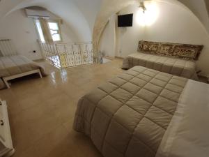 a large room with two beds and a staircase at B&B Punta Cutieri in Gallipoli