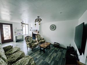 a living room with a couch and chairs and a table at Gîte de Montapeine 8 in Breteau