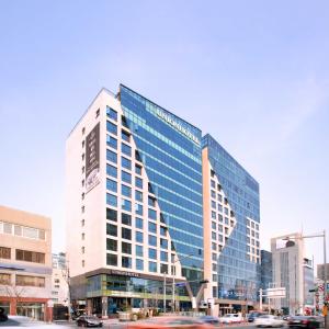 a tall building with glass windows in a city at Union Hotel in Seoul