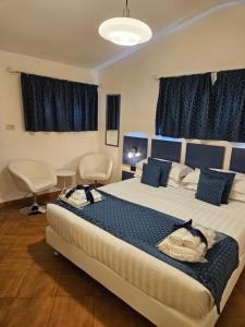 a bedroom with a large bed with blue curtains at Albis Rooms Guest House in Fiumicino