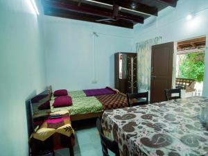 a bedroom with two beds and a window at Sanctuary View Homestay Thattekad in Ernakulam