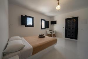 a bedroom with a bed and a table in it at Caves 1880 in Oia