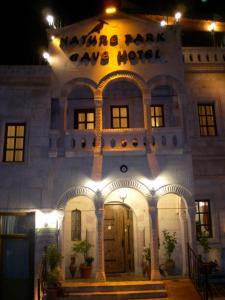 a building with a sign that says were more thanave hotel at Nature Park Cave Hotel in Goreme