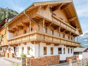 a large wooden house with a gambrel roof at Apartment in Hainzenberg in a ski area in Hainzenberg