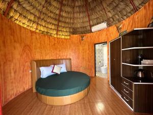 a bedroom with a round bed in a hut at King Bavi Resort in Xóm Cầu Rồng