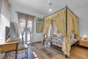 a bedroom with a canopy bed in a room at Dennis City Center Elegant Apartment (2) in Zakynthos Town