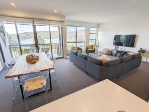 a living room with a couch and a table at Jasper 3 in Jindabyne