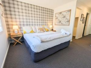 a bedroom with a large bed and two night stands at Jasper 3 in Jindabyne