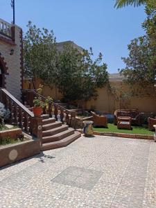 a patio with a set of stairs and a garden at Marsa Matrouh in Marsa Matruh