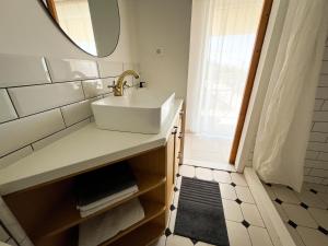 a bathroom with a sink and a mirror at Old stone house Klarić in Brela +29 photos