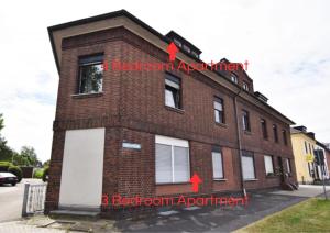 a brick building with two red arrows on it at Voll ausgestattete Unterkunft mit 3 Schlafzimmern in Bedburg-Hau in Bedburg