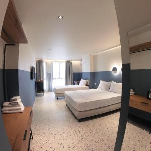 Postel nebo postele na pokoji v ubytování Rich Boutique Hotel