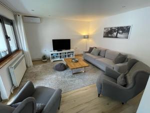 a living room with two couches and a television at Salam Sarajevo Apartments #HelloPeace in Sarajevo