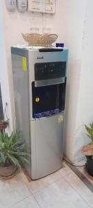 a stove top oven sitting next to a refrigerator at MK Hostel in Luang Prabang +26 photos