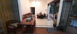 a room with a table and chairs and a dining room at MK Hostel in Luang Prabang