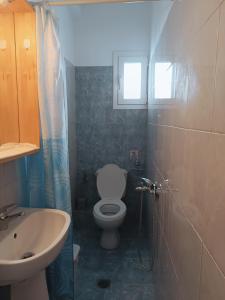 a bathroom with a toilet and a sink at Niki Seaside Apartments in Platamonas