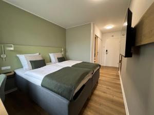 Postel nebo postele na pokoji v ubytování Vingsted Hotel & Konferencecenter