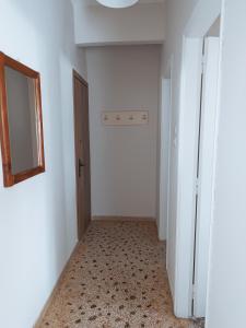 an empty hallway with a door and a mirror at Niki Seaside Apartments in Platamonas