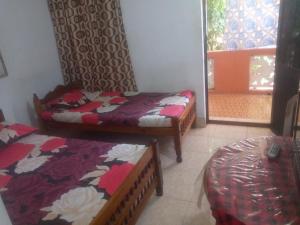 Ένα ή περισσότερα κρεβάτια σε δωμάτιο στο Kunam Beach Rest Inn