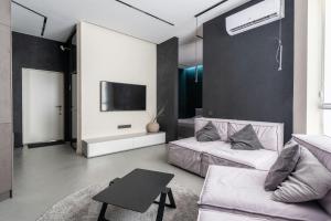 a living room with a couch and a tv at Great Gravity Hotel in Durban