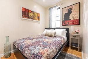 a bedroom with a bed and a vase on the floor at Luxury Four Bedroom Suite in New York