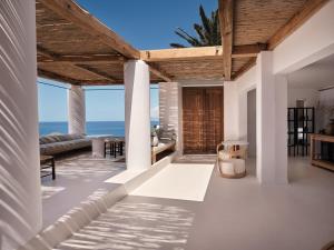 an open living room with a view of the ocean at Boheme Mykonos Town - Small Luxury Hotels of the World in Mikonos