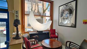 a living room with a table and chairs and a window at Trianon in Vichy