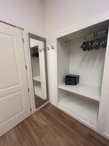 a room with a closet with a door and a mirror at Hotel Milano in Cesenatico