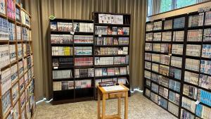 a book store with a book shelf filled with books at Garden Hotel Matsumoto in Matsumoto