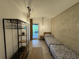 a room with two bunk beds and a hallway at Apart Home Bieszczady in Uherce Mineralne (7)