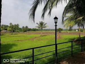 a street light next to a fence and a field at Rajarata Villa Anuradhapura in Anuradhapura