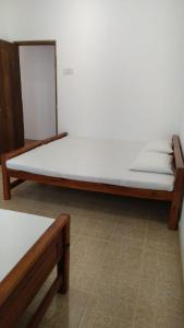 a large bed in a room with a white mattress at Rajarata Villa Anuradhapura in Anuradhapura