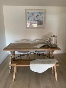a wooden table sitting in a room with a table at El Sol Zandvoort 2 in Zandvoort