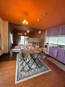 a kitchen with a table and some purple cabinets at 777 Takamatsu Guest House in Takamatsu