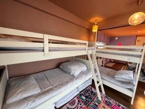 a bunk bed room with two bunk beds in it at 777 Takamatsu Guest House in Takamatsu