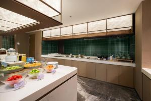 a large kitchen with bowls of food on a counter at Atour Hotel Chongqing Liangjiang Happiness Plaza in Chongqing