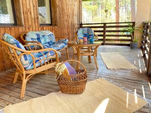 a porch with chairs and a table on a deck at Cozy home in Tallinn in Tallinn