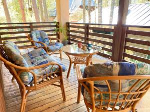 a porch with chairs and a table on a deck at Cozy home in Tallinn in Tallinn