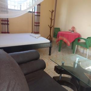 a living room with a couch and a table at Zaradise Suites in Mombasa