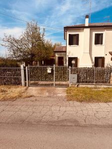 a white fence in front of a house at Vila Romaneasca in Corbola