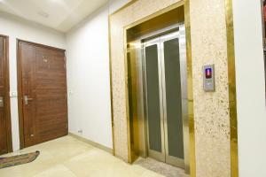a elevator in a building with a wooden door at FabExpress 56 Amritsar in Amritsar