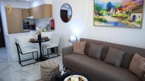 a living room with a couch and a table at City Chic: Elegant 1BR Apartment in Abu Dhabi